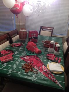 a football themed table with balloons and decorations