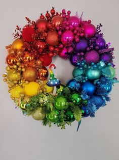 a christmas wreath with ornaments hanging from it