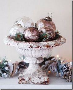 a white bowl filled with ornaments on top of a table