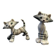 two ceramic cats sitting next to each other