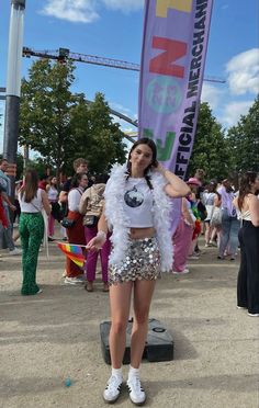 a woman standing in front of a banner at a festival