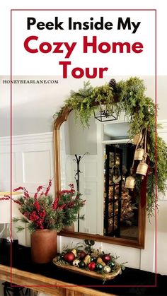 a mirror sitting on top of a wooden table next to a potted plant and christmas decorations