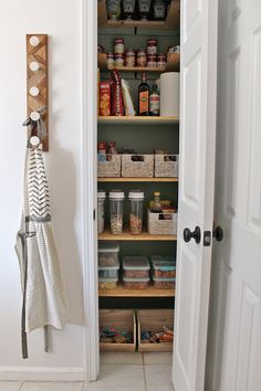 an open pantry door with spices and other items on shelves next to the closet doors