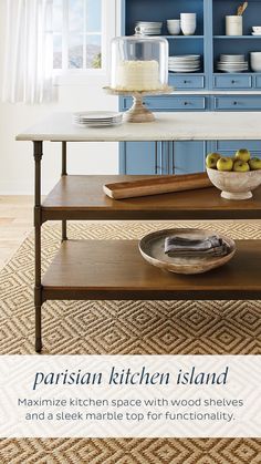 a kitchen island with plates and bowls on it in front of a blue hutch