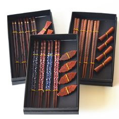 three boxes with different types of chopsticks in them