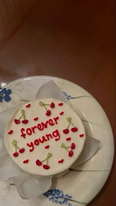 a cake with writing on it sitting on a plate