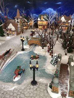 a christmas village scene with santa sleighs and reindeer in the snow near a pond