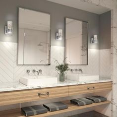 a bathroom with two sinks and mirrors on the wall