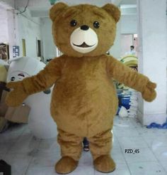 a large brown teddy bear standing in the middle of a room with white tile flooring