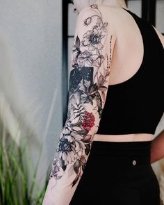 a woman with a flower tattoo on her arm