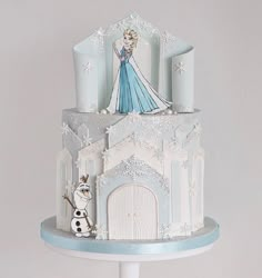 a frozen princess themed cake with frosting and icing decorations on the top tier