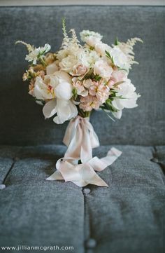 a bouquet of flowers sitting on top of a couch next to an instagram page