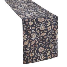 a black table runner with floral designs on the top and bottom, along with a white background