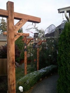 a wooden cross sitting in the middle of a yard