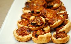 small pastries are arranged on a white plate