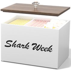 a white box with the words shark week written on it and an open lid in front