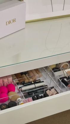 the drawer is filled with makeup and other items