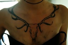 a woman with a deer's head tattoo on her chest