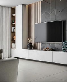 a living room with a large flat screen tv mounted to the side of a wall