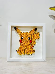 a paper cut out of a pikachu with red eyes