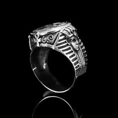 a silver ring with an image of a man's head on the front and sides