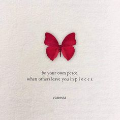 a red butterfly sitting on top of a piece of paper with a quote written below it