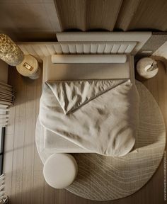 an overhead view of a bed with white sheets and pillows on it, next to a radiator