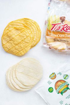 tortilla chips, yellow corn tortillas, and other ingredients laid out on a white surface