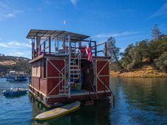 there is a small house on the water with a life guard tower attached to it