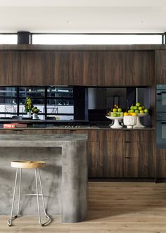 a modern kitchen with an island counter and stools