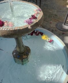 a water fountain with flowers on it