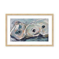 three seashells on the beach with blue water and white background, framed in wooden frame