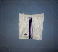 "Vintage 80/90s Trefoil Adults' Running Training Shorts Authentic ADIDAS Trefoils. EXCELLENT Vintage Condition .  White colour with Violet stripes and logo. Please see pics for details  Polyamide, Cotton Label Size :D 7, UK 36, USA L. Adults' Please to fit better read the measurements below. Elastic Waist 16,5 to  20.5 inch, 42 to 52 cm. Round Waist 22-41\" Lenght 14 in. , 36 cm.(on the side) WASHED and SANITIZED  We Post From Italy This is a PRIVATE SALE The Photos are Real of the Item I sell i White Bottoms With Three Stripes For Jogging, Vintage Style White Bottoms For Streetwear, White Jogging Bottoms With Three Stripes, White Three Stripes Jogging Bottoms, Vintage White Bottoms For Streetwear, White Jogging Bottoms With Three Stripes Branding, Vintage White Streetwear Bottoms, Adidas Three Stripes Athletic Shorts, Vintage Adidas Shorts