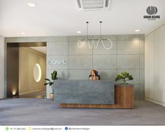 a woman is sitting at the front desk of a modern office lobby with planters on either side