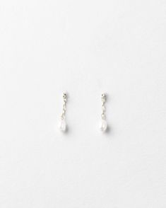 In the forecast: a soft shower of pearls.Make your earscape dance with tiny freshwater pearls dropped from the daintiest chain—a whisper, not a shout. Ideal for your wedding day, every day or a pearls’ night out. Sold as a pair.Pair with the rest of the dream team: our Pearl Droplet Necklace, Bracelet and Anklet. As with any pearl piece, we recommend keeping away from harsh cleansers and beauty products, wearing them often, storing them in linen or cloth (no airtight containers) and gently wipin Dainty Pearl Charm Earrings For Parties, Delicate Drop Pearl Jewelry, Briolette Pearl Charm Earrings For Weddings, Delicate Sterling Silver Earrings With Pearl Chain, Dainty Teardrop Pearl Chain Earrings, Minimalist Silver Pearl Drop Bridal Earrings, Dainty Drop Earrings With Pearl Chain, Minimalist Silver Bridal Earrings With Pearl Drop, Dainty Sterling Silver Pearl Chain Earrings