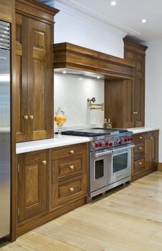 a kitchen with wooden cabinets and stainless steel appliances