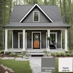 a gray house with white trim and wooden door