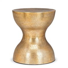 a gold colored stool that is sitting on a white surface