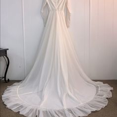 a white wedding dress hanging on a wall