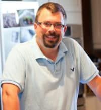 a man standing in front of a refrigerator