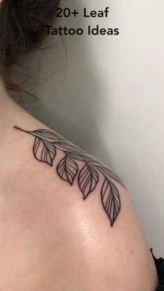 the back of a woman's shoulder with tattoos on it and leaves in black ink