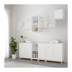 an image of a living room setting with white furniture and bookshelves on the wall