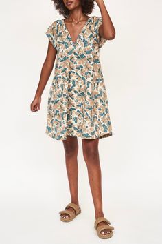 Komodo Dress in Plumeria – MIRTH Casual Cotton V-neck Wrap Dress, V-neck Linen Dress With Floral Print, V-neck Tie Waist Dress For Daywear, V-neck Sundress Midi Dress, V-neck Unlined Midi Sundress, Unlined V-neck Sundress Midi Dress, Beach Dress With Tie Waist And Flutter Sleeves, Linen V-neck Midi Dress With Ruffles, Cotton V-neck Vacation Dress