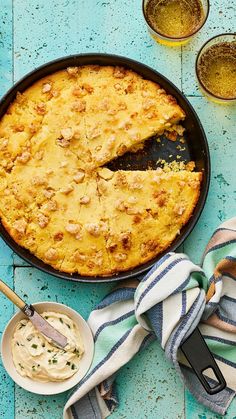 a skillet pie with a slice cut out and bowls of dips next to it