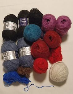 several skeins of yarn sitting next to each other on top of a table