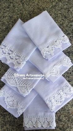 five white napkins with lace on them