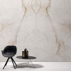 a chair and table in front of a marble wall