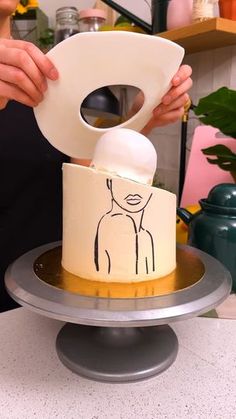 a woman is cutting into a cake with a paper towel on it's side