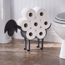 several rolls of toilet paper are stacked on top of each other in front of a toilet