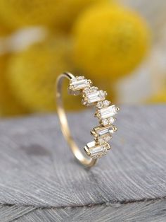 a diamond ring sitting on top of a wooden table